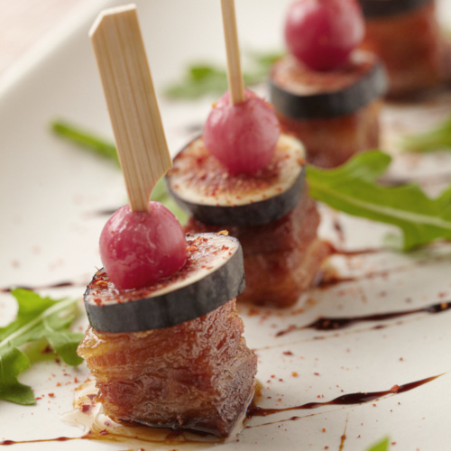 Eggplants and meat bites with arugula and cherry tomatoes closeup